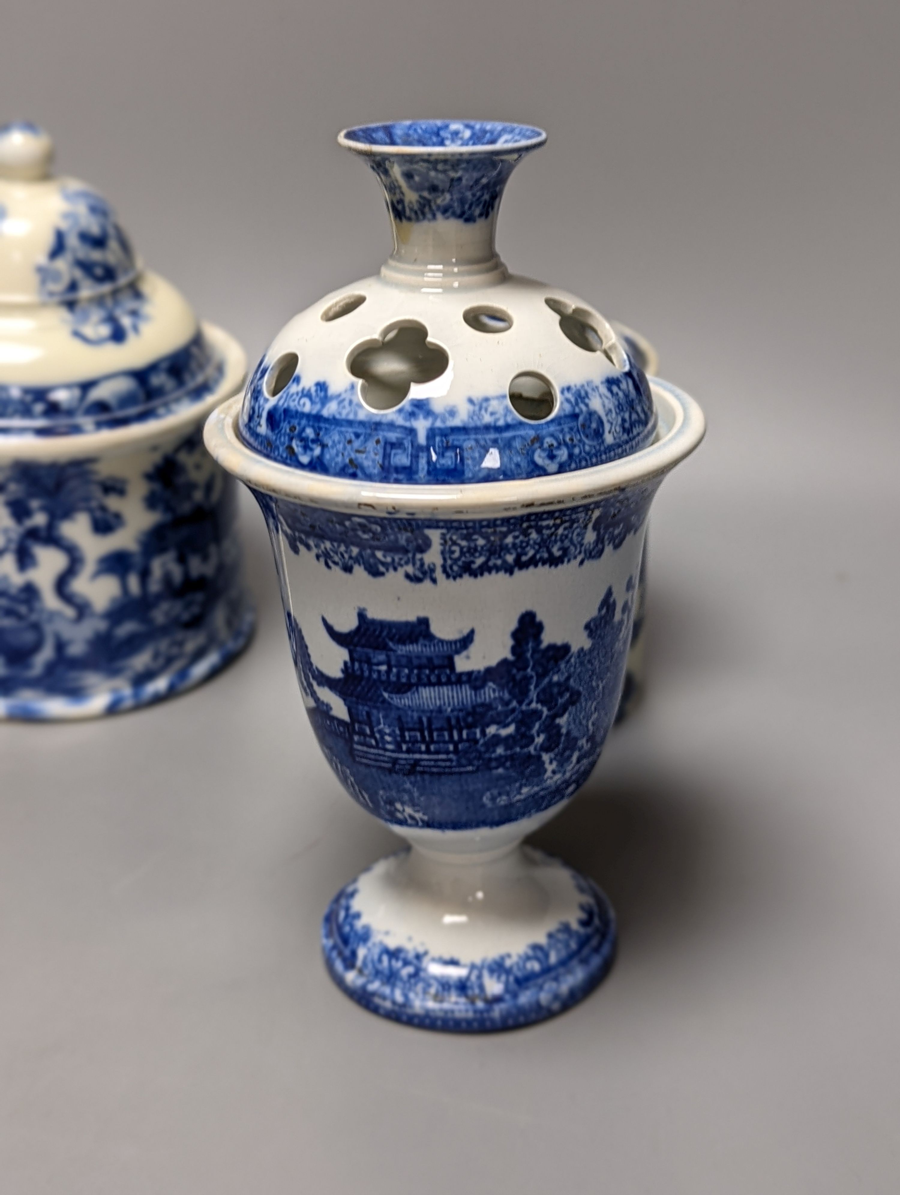 Four items of early 19th century blue and white pearlware pottery, an 18th century Delft blue and white vase and a 19th century toothbrush holder, Delft vase 22 cms high.